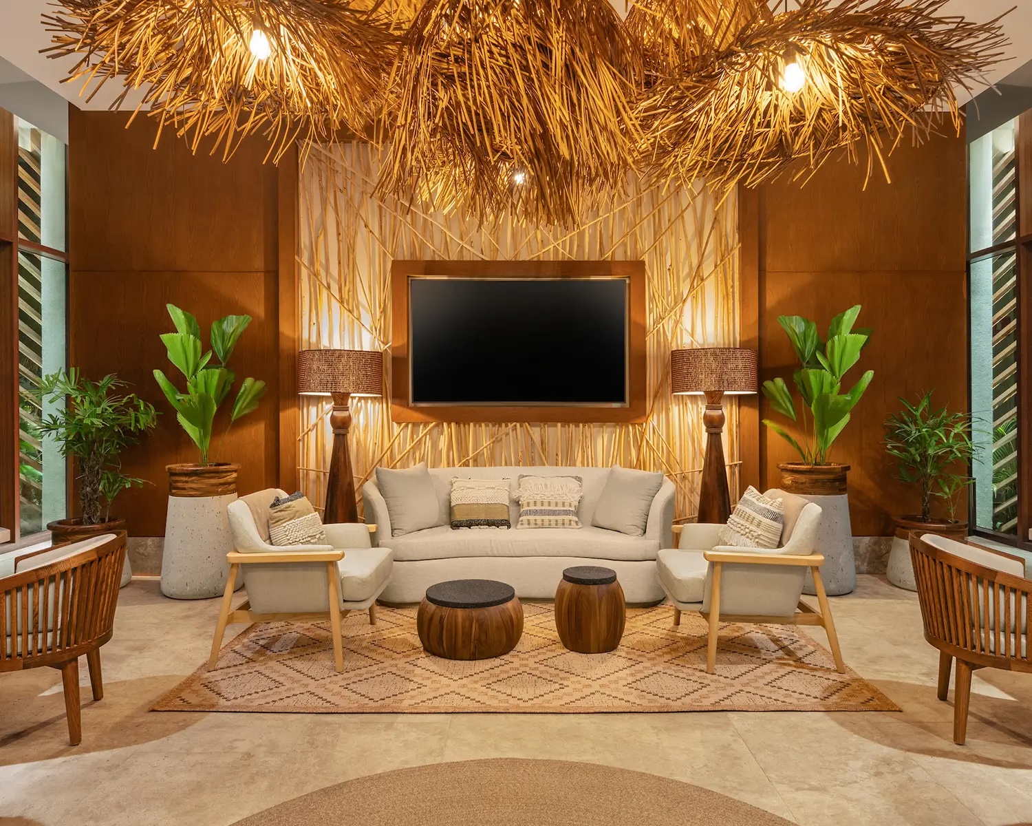 Lounge area at The Estates in Vidanta Riviera Maya, featuring an artisanal palapa-style chandelier and contemporary tropical design