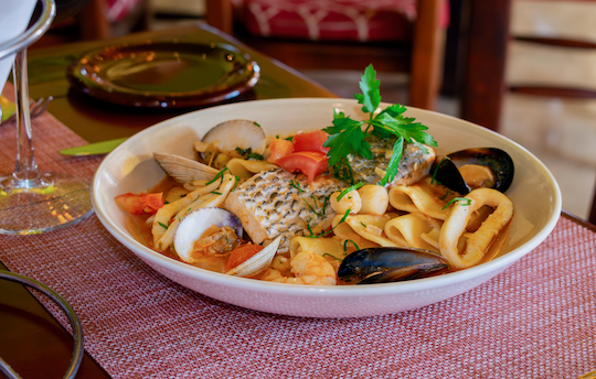 Pan-seared snook fillet with shrimp, scallops, calamari rings, Manila clams, and black mussels in a white wine and lobster bisque sauce. Served with paccheri pasta.
